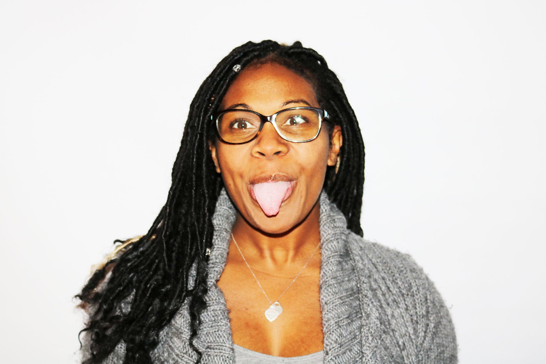 photography of woman showing her tongue